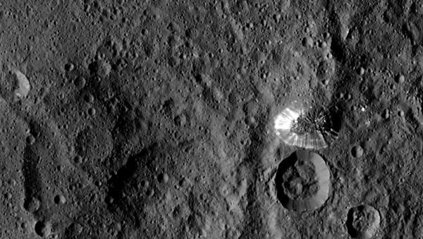 An image of a lone mountain on the surface of dwarf planet Ceres...taken by NASA's Dawn spacecraft from a distance of 915 miles (1,470 kilometers) on August 19, 2015.