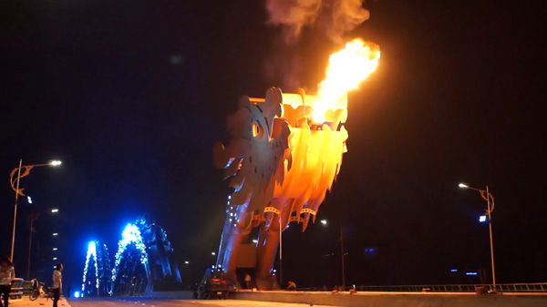 A night shot of Vietnam's Dragon Bridge shooting out fire.