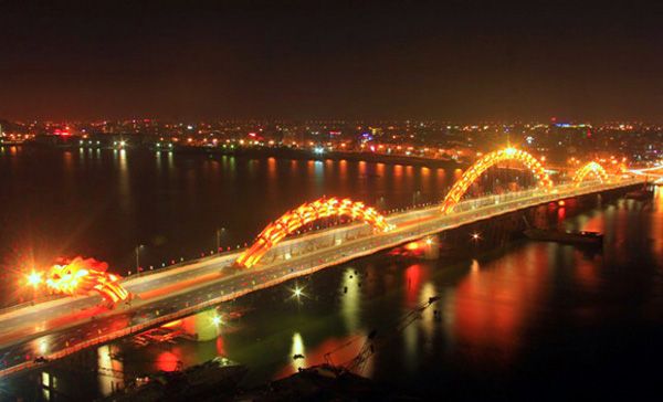 A night shot of the Dragon Bridge above the Han River in Da Nang, Vietnam.