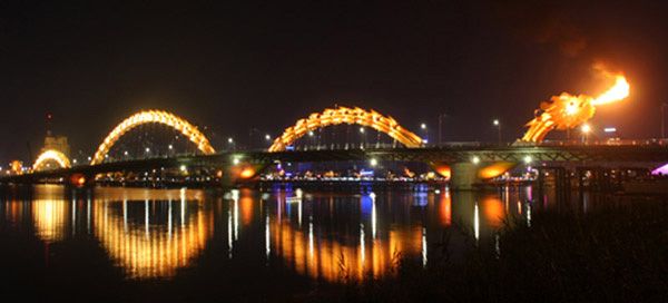 A night shot of the Dragon Bridge shooting out fire above the Han River in Da Nang, Vietnam.