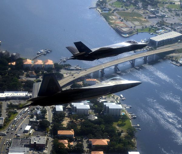 An F-22 Raptor and F-35 Lightning II fly in formation for a training mission.