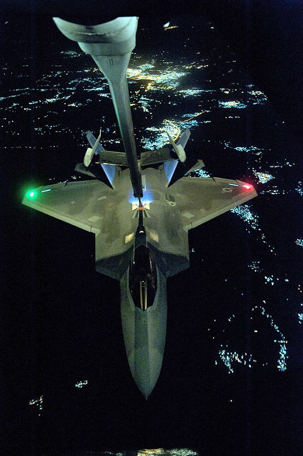 An F-22 Raptor gets refueled in mid-flight by a KC-10 Extender prior to conducting a combat sortie in Syria, on September 26, 2014.