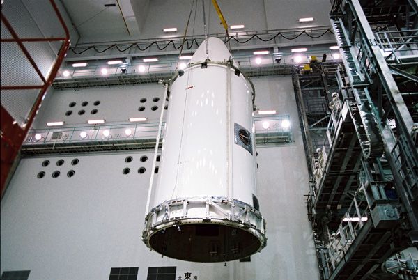 At the Tanegashima Space Center in Japan, the payload fairing of the H-IIA launch vehicle is about to encapsulate JAXA's Hayabusa 2 spacecraft (not visible)...on November 17, 2014.