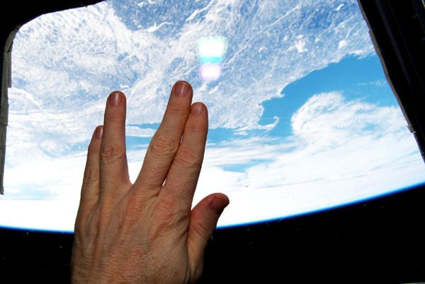 In honor of the late Leonard Nimoy, astronaut Terry Virts does the Vulcan hand salute inside the Cupola aboard the International Space Station...on February 27, 2015.
