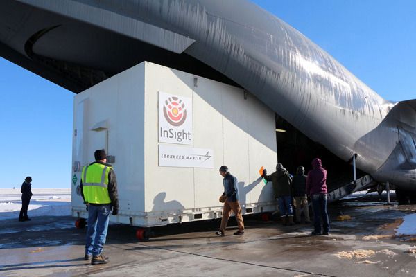 A shipping container holding NASA's InSight Mars lander is about to be loaded onto a C-17 aircraft for transport to Vandenberg Air Force Base in California, where the spacecraft will launch from in March of 2016.