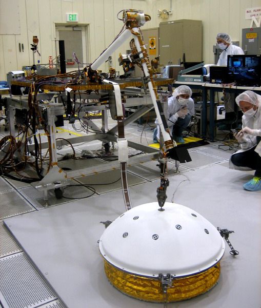 Engineers at Lockheed Martin test the robotic arm of NASA's InSight lander...set to launch towards Mars on March 4, 2016.