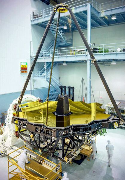 At NASA's Goddard Space Flight Center in Greenbelt, Maryland, the James Webb Space Telescope's primary and secondary mirrors are unveiled inside the clean room prior to the installation of the craft's science instruments.