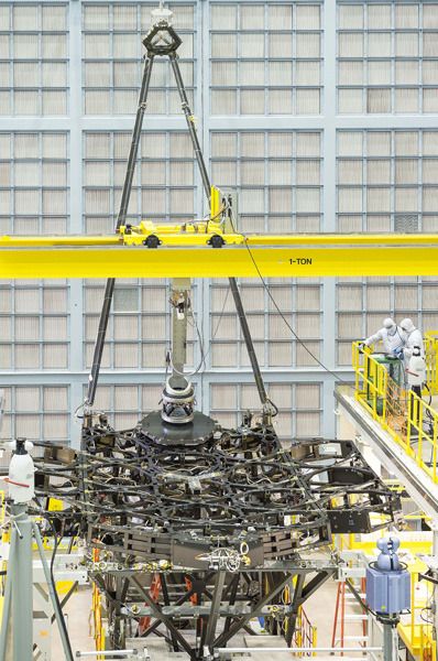 Engineers install the first of 18 mirror segments onto the James Webb Space Telescope's backplane at NASA's Goddard Space Flight Center in Greenbelt, Maryland.