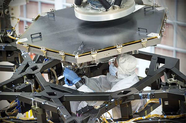 Engineers install the first of 18 mirror segments onto the James Webb Space Telescope's backplane at NASA's Goddard Space Flight Center in Greenbelt, Maryland.