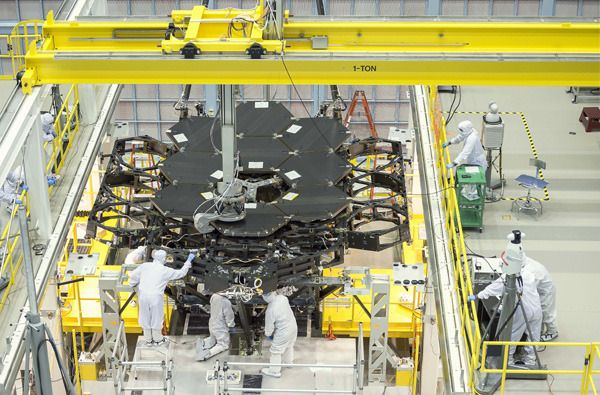 Engineers install the ninth of 18 mirror segments onto the James Webb Space Telescope's backplane at NASA's Goddard Space Flight Center in Greenbelt, Maryland.