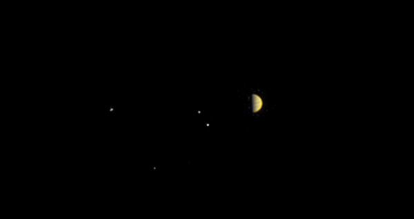 Jupiter and its four Galilean moons as seen by NASA's Juno spacecraft at a distance of 6.8 million miles (10.9 million kilometers) away...on June 21, 2016.