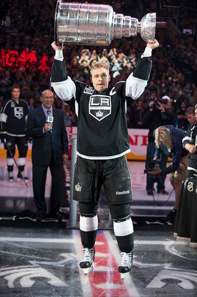 Team captain Dustin Brown shows off the Stanley Cup trophy to the STAPLES Center crowd during the L.A. Kings' opening game ceremony, on October 8, 2014.