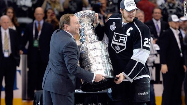 Los Angeles Kings team captain Dustin Brown poses with NHL Commissioner Gary Bettman after the Kings defeated the New York Rangers, 3-2, in Game 5 of the Stanley Cup Finals at STAPLES Center...on June 13, 2014.