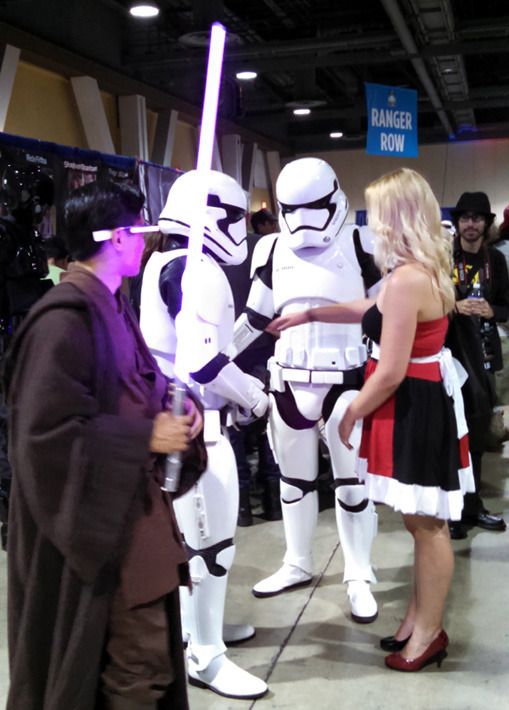 A Jedi cosplayer welding Mace Windu's lightsaber wonders if he needs to neutralize those First Order Stormtroopers in order to get that girl's digits...at Long Beach Comic Con on September 12, 2015.