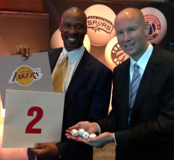 Byron Scott and head of PR John Black hold up the card and ping pong balls that brought the #2 NBA Draft pick to the Los Angeles Lakers...on May 19, 2015.