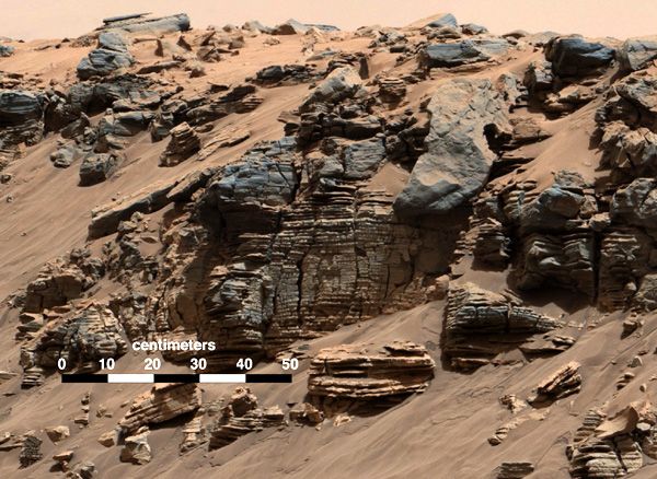 An image of several layered rocks that was taken by NASA's Curiosity Mars rover on August 7, 2014, showing evidence of a sedimentary deposit that possibly came from flowing water entering an ancient lake.