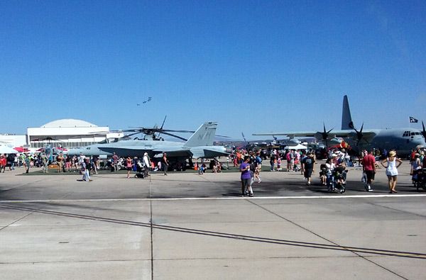 While another air demo takes place in the background, an F/A-18 Hornet, a C-130 Hercules and other aircraft are on display at the Miramar Air Show...on September 24, 2016.