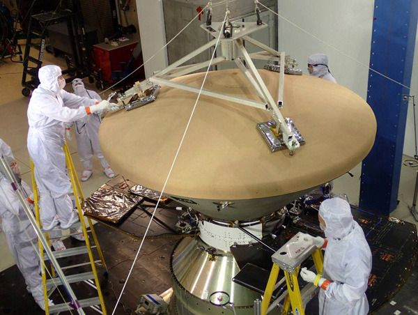 The heat shield is attached to the aeroshell that enshrouds NASA's InSight Mars lander at the Lockheed Martin facility near Denver, Colorado.