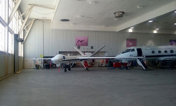 An Ikhana Predator B drone and Gulfstream III aircraft rest inside a hangar at NASA's Armstrong Flight Research Center in Edwards Air Force Base...on May 31, 2016.