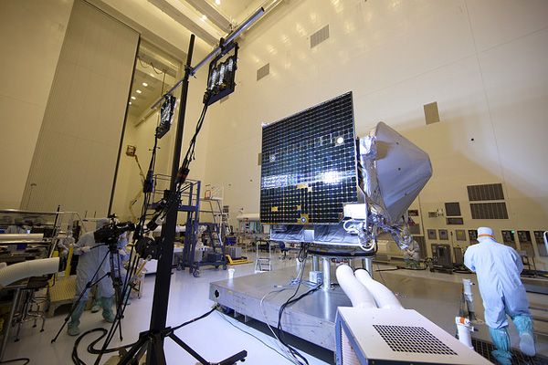 At NASA's Kennedy Space Center in Florida, an illumination test is conducted on one of OSIRIS-REx's twin solar arrays inside the Payload Hazardous Servicing Facility.