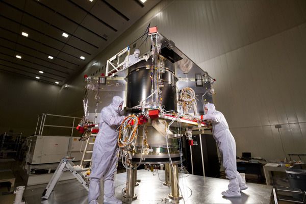 At the Lockheed Martin facility in Littleton, Colorado, engineers work on the OSIRIS-REx spacecraft after its core structure was combined with its hydrazine fuel tank and boat tail assembly.