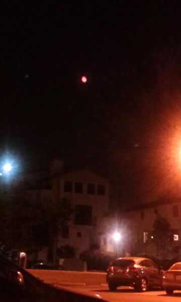 As seen from old town Pasadena, the Moon is tinted red by a cloud of smoke caused by the Sand Fire in Santa Clarita...on July 22, 2016.