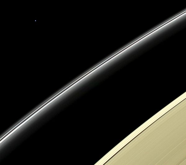 The pale blue dot of Uranus floats high above Saturn's rings in this image taken by NASA's Cassini spacecraft...on April 11, 2014.