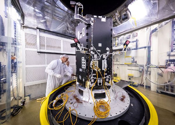 At the Johns Hopkins University Applied Physics Laboratory in Laurel, Maryland, technicians prepare the Solar Probe Plus spacecraft—which is still undergoing construction—for thermal vacuum tests that simulate conditions in space.