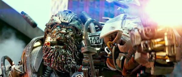 Hound (voiced by John Goodman) fires away at Decepticons in TRANSFORMERS: AGE OF EXTINCTION. Hound (voiced by John Goodman) fires away at Decepticons in TRANSFORMERS: AGE OF EXTINCTION.