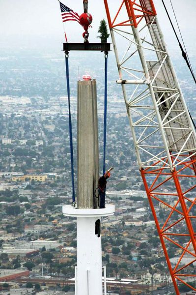 A construction worker stands on the final spire segment as it was being installed atop the Wilshire Grand Center on September 3, 2016.