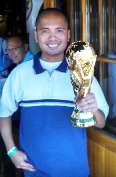 Getting photobombed while holding a replica of the World Cup trophy at the Legends sports bar in Long Beach, CA...on July 13, 2014.