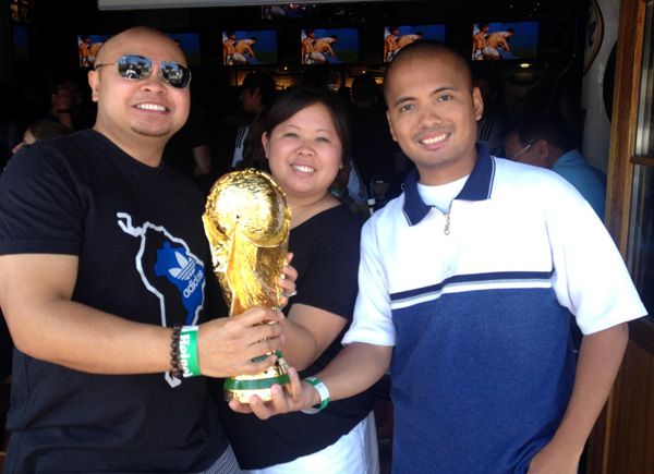 Two of my friends and I pose with the World Cup trophy replica at the Legends sports bar in Long Beach, CA...on July 13, 2014.
