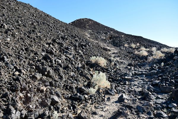 Standing at the base of the trail that leads up the slope to Amboy Crater's volcanic rim...on December 2, 2018.