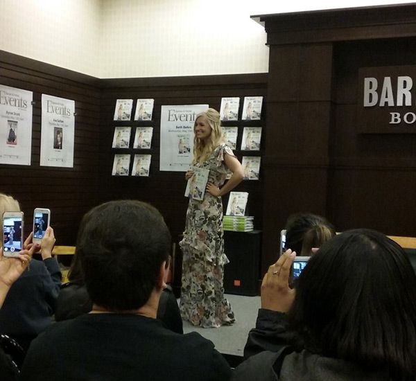 Beth Behrs poses with her new publication THE TOTAL ME-TOX at The Grove's Barnes & Noble bookstore in Los Angeles...on May 10, 2017.