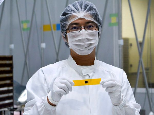 A JAXA technician displays the memory card that holds the names and messages of 6,494 people that is flying aboard Japan's MIO satellite to Mercury.
