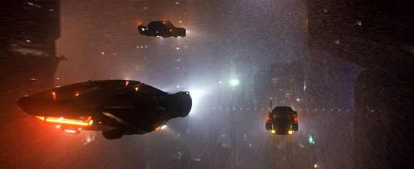 Futuristic cars fly through the city of Los Angeles in BLADE RUNNER 2049.