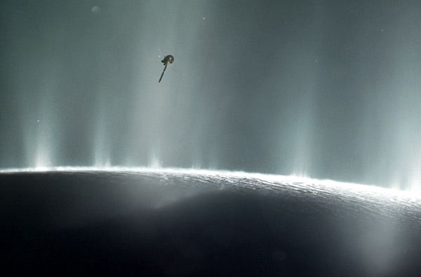 An artist's concept of NASA's Cassini spacecraft flying through plumes of water vapor erupting from the surface of Saturn's moon Enceladus.