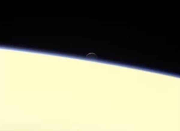 An image of the ocean-bearing moon Enceladus disappearing behind Saturn...as seen by NASA's Cassini spacecraft on September 13, 2017.
