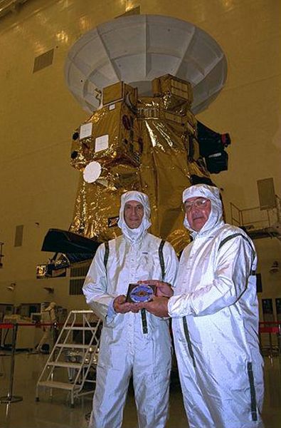 Former Cassini-Huygens mission team members Charley Kohlhase (left) and Richard Spehalski pose with the DVD at NASA's Kennedy Space Center in Florida...prior to Cassini's launch on October 15, 1997.