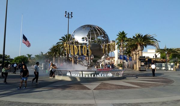 A snapshot of the Universal Logo display and water fountain at the entrance of Citywalk and Universal Studios...on September 1, 2018. The U.S. flag is at half-mast to honor the late Senator John McCain.