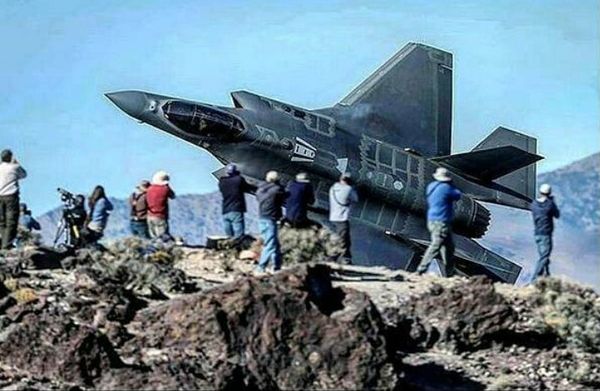 A group of photographers take snapshots of an F-35A Lightning II zooming past them...most likely at 'Star Wars Canyon' in Death Valley, California.