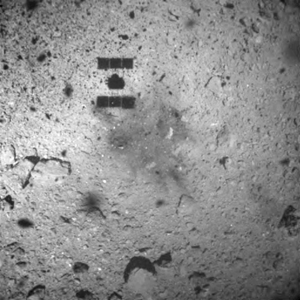 Hayabusa2's shadow is visible on Ryugu's surface as the spacecraft began its ascent after collecting its first rock samples from the asteroid...on February 21, 2019 (Pacific Time).