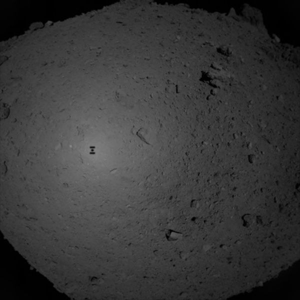 Hayabusa2's shadow is visible on Ryugu's surface as the spacecraft descended towards the asteroid to collect its first rock samples...on February 21, 2019 (Pacific Time).