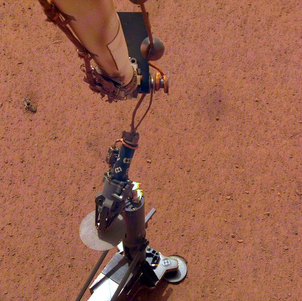 An image of the InSight lander's robotic arm placing the Heat Flow and Physical Properties Package on the surface of Mars...on February 12, 2019.