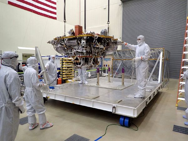 Lockheed Martin engineers take the InSight Mars lander out of temporary storage in June of 2017...to begin testing the spacecraft prior to its launch in May of 2018.