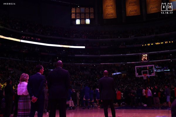 From right to left: Kobe Bryant, Magic Johnson, Kobe's former agent (and now Lakers general manager) Rob Pelinka and Jeanie Buss watch as Bryant's two jersey numbers are retired during a halftime ceremony at STAPLES Center...on December 18, 2017.