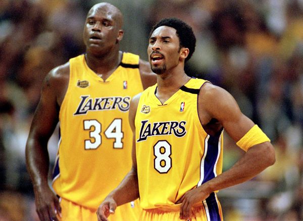Shaquille O'Neal and Kobe Bryant don Lakers jerseys that were redesigned for the 1999-2000 NBA season...the year that Shaq and Kobe won their first championship.