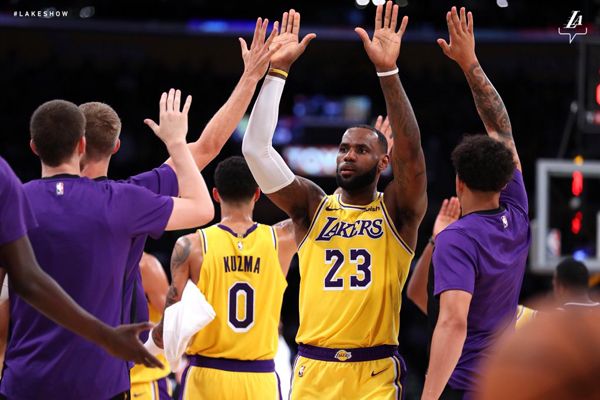 LeBron James high-fives his teammates during the Lakers' exhibition game against the Denver Nuggets at STAPLES Center in Los Angeles...on October 2, 2018.