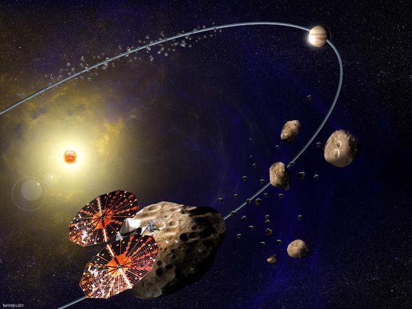 An artist's concept of the Lucy spacecraft exploring Trojan asteroids in Jupiter's orbit.