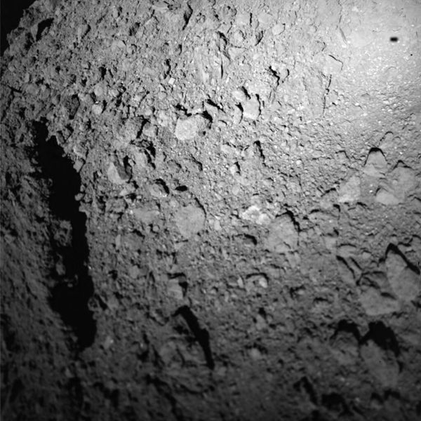 The shadow of the German-made MASCOT (Mobile Asteroid Surface Scout) is visible on Ryugu's surface (at upper right) as the lander descended towards the asteroid on October 3, 2018 (Japan Time).